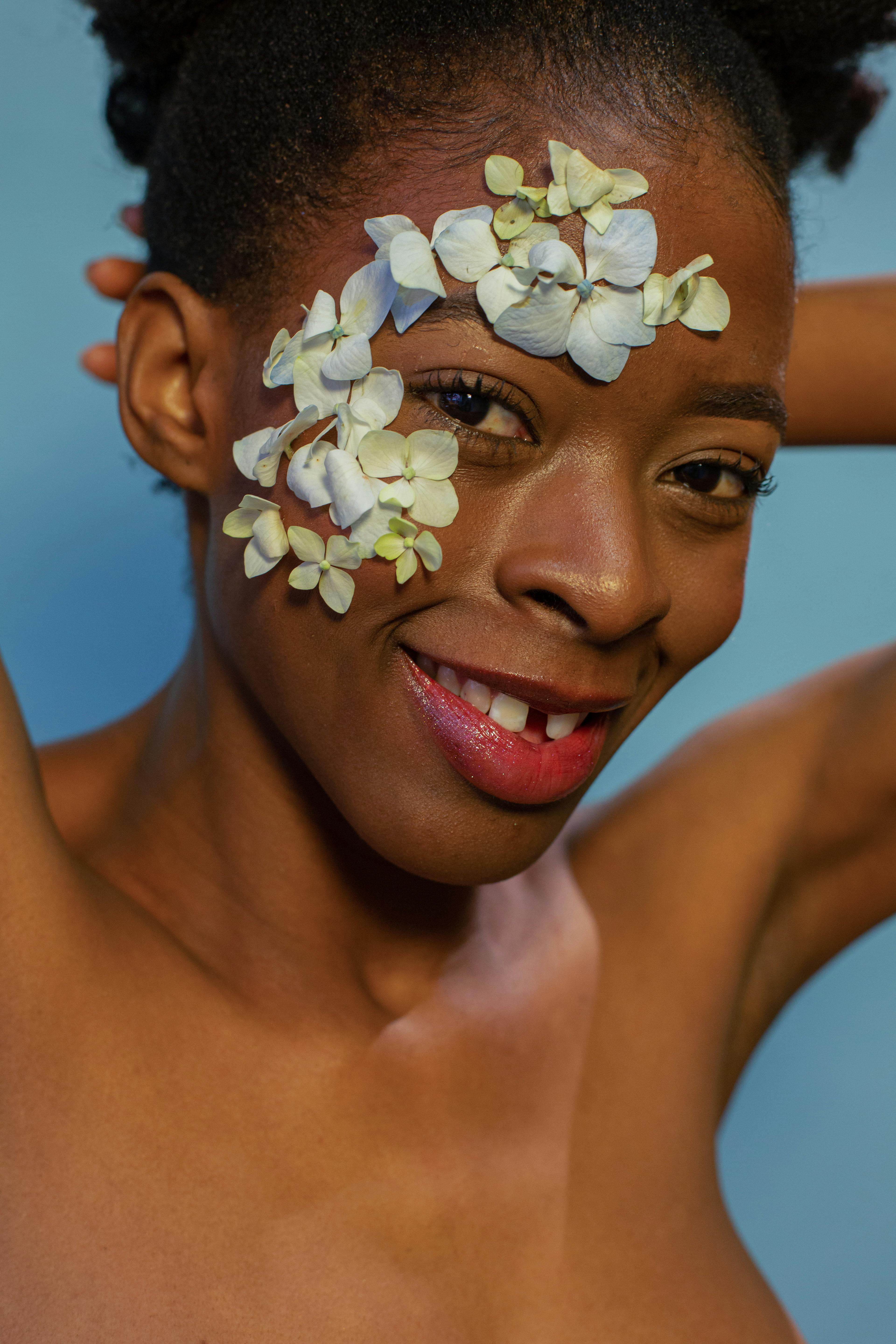 portrait of a woman with flowers on her face