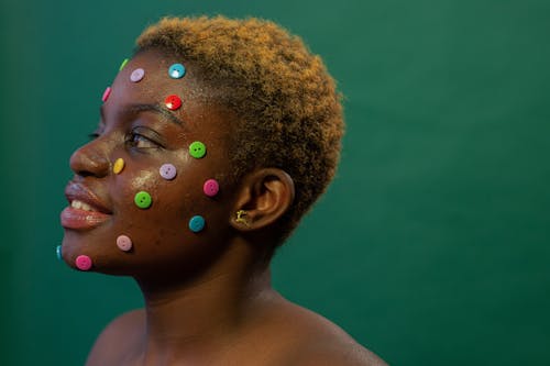Free A Topless Woman Smiling with Buttons on Her Face Stock Photo