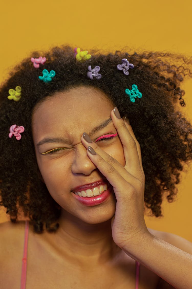 Joyful Ethnic Woman Wearing Multicolored Hair Clasps Touching Face