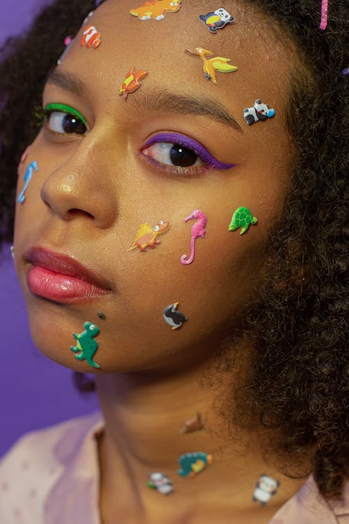 Crop black woman with childish stickers on face