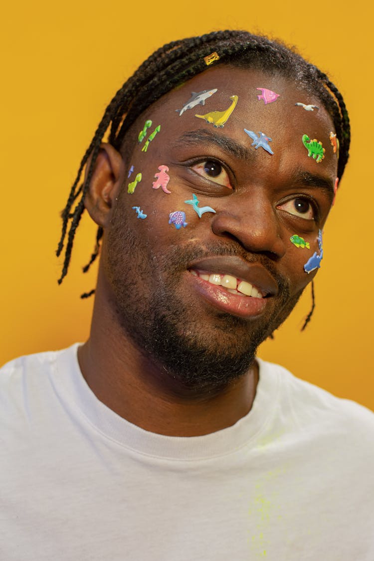 Smiling Black Man With Colorful Childish Stickers On Face