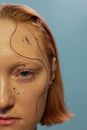 Crop unemotional woman with glitters on face