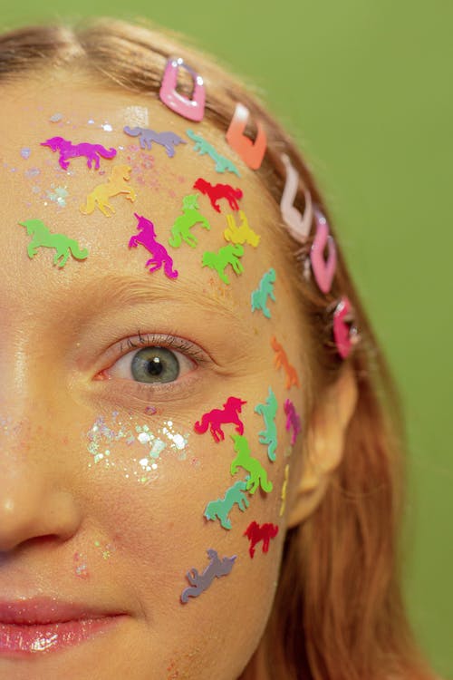 Amazed woman with multicolored stickers on face