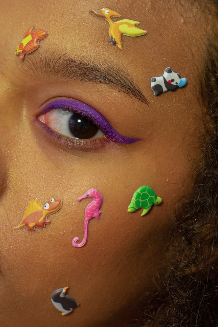Crop Unrecognizable Ethnic Woman With Colorful Animal Stickers On Face