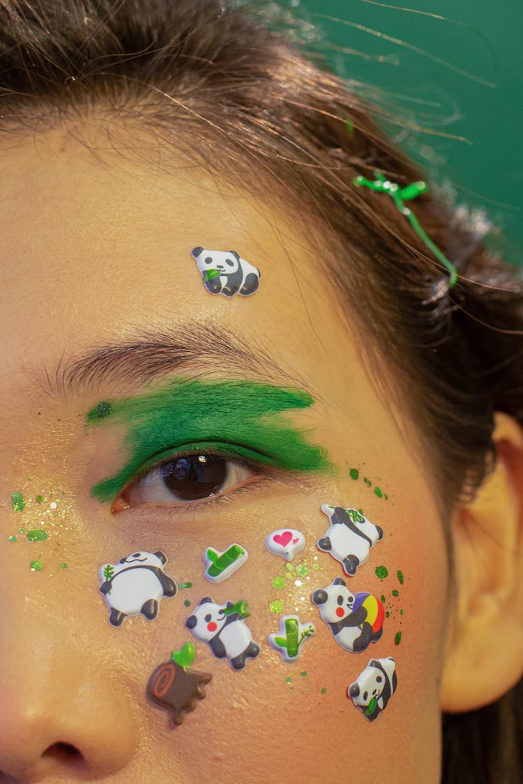 Crop Ethnic Female Model With Funny Face Stickers And Bright Makeup In Studio