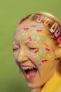 Young woman with childish stickers on face shouting in studio