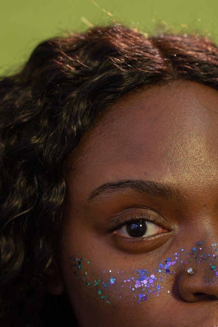 Crop Black Woman With Blue Glitters On Face In Studio