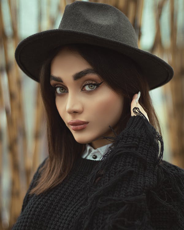 A Woman in Black Hat and Black Sweater · Free Stock Photo