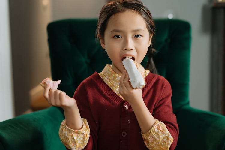 A Girl Eating A Cake 