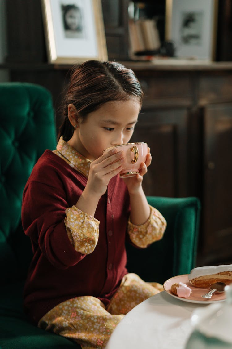 A Girl Drinking From A Cup