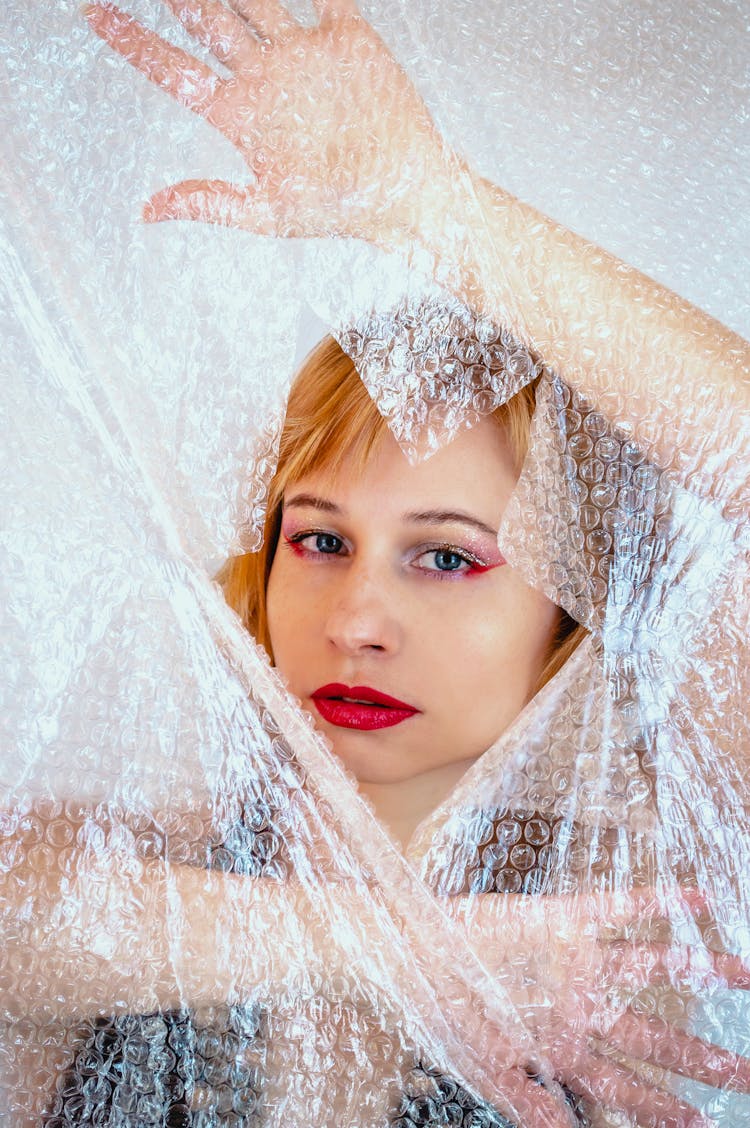 Model With Red Lips Behind Bubble Wrap