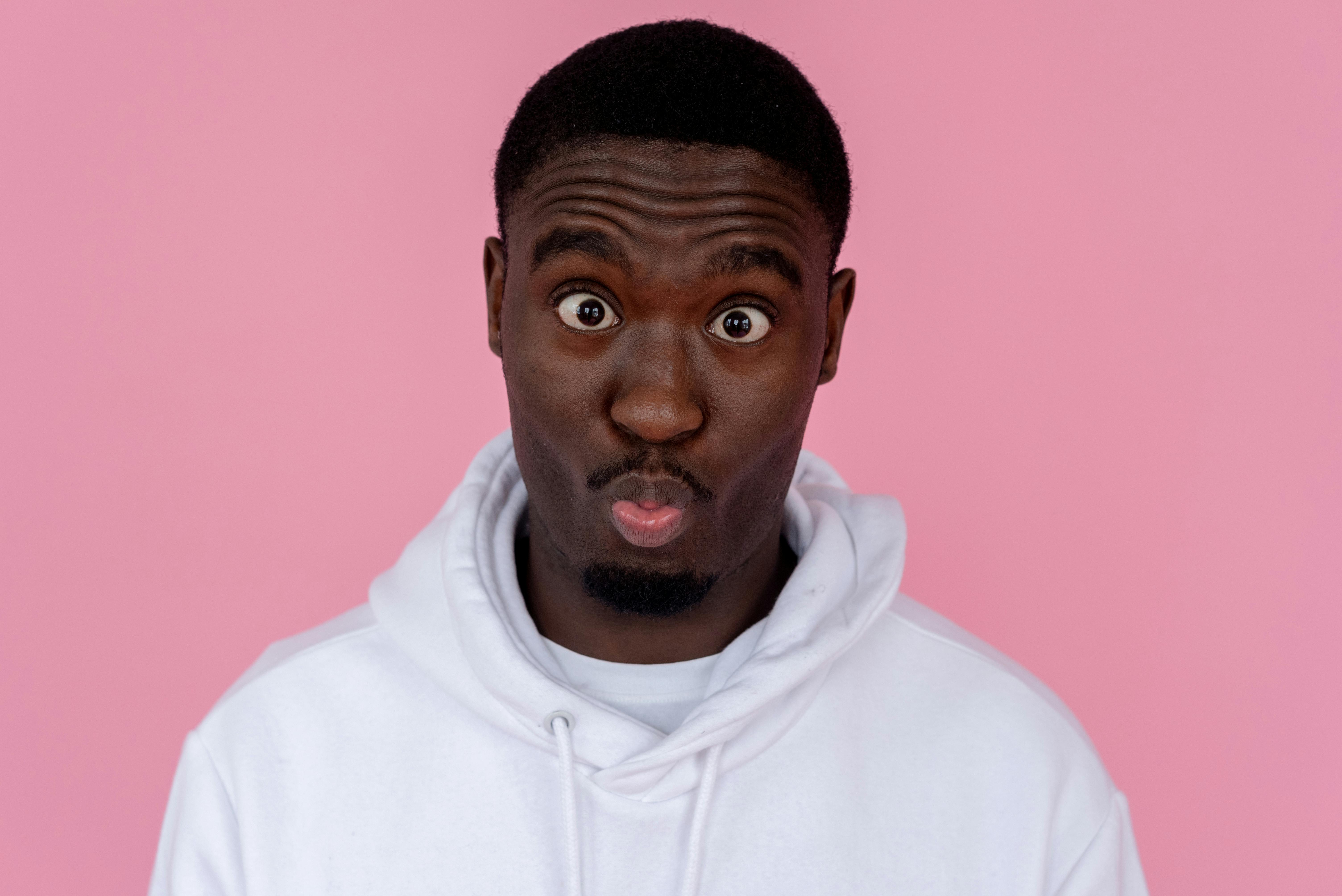 Funny black man making grimace and pouting lips · Free Stock Photo