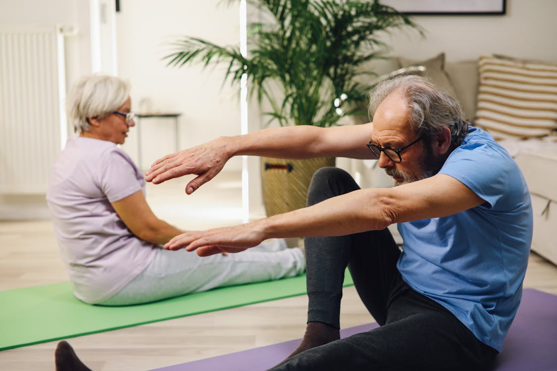 Man in White T-shirt and Black Pants Doing Yoga