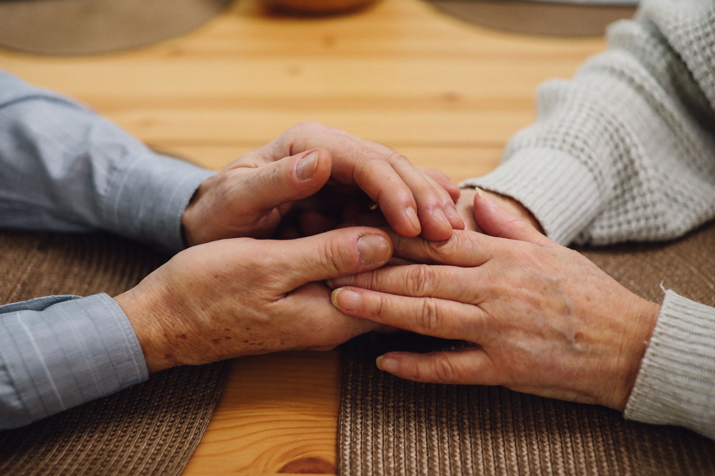 Close-up of an elderly couple's hands held together