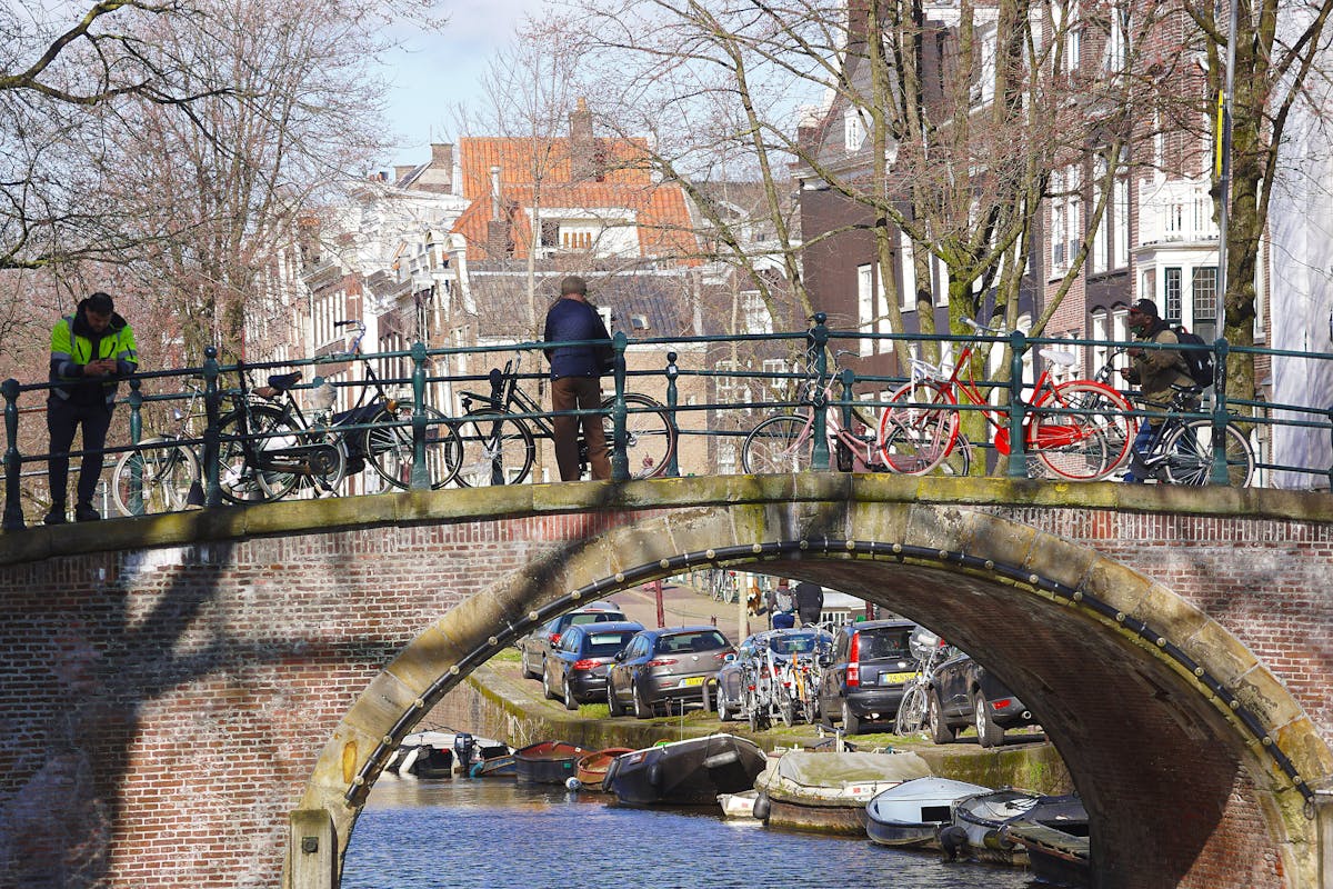 Tired person resting on a couch holding a mug, appearing fatigued