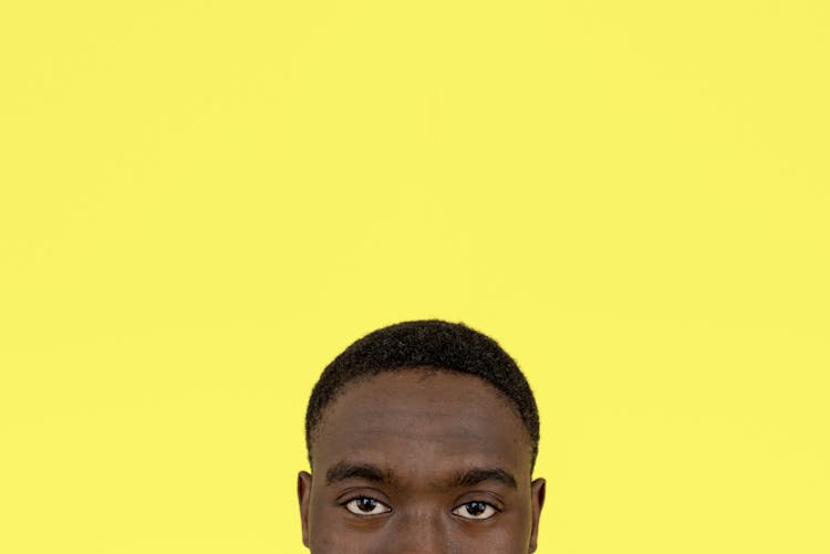 Eyes And Hair Of A Man On Yellow Background