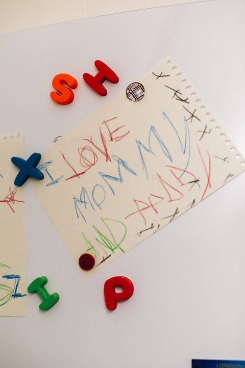 Free A child's crayon drawing expressing love for parents on a fridge door. Stock Photo