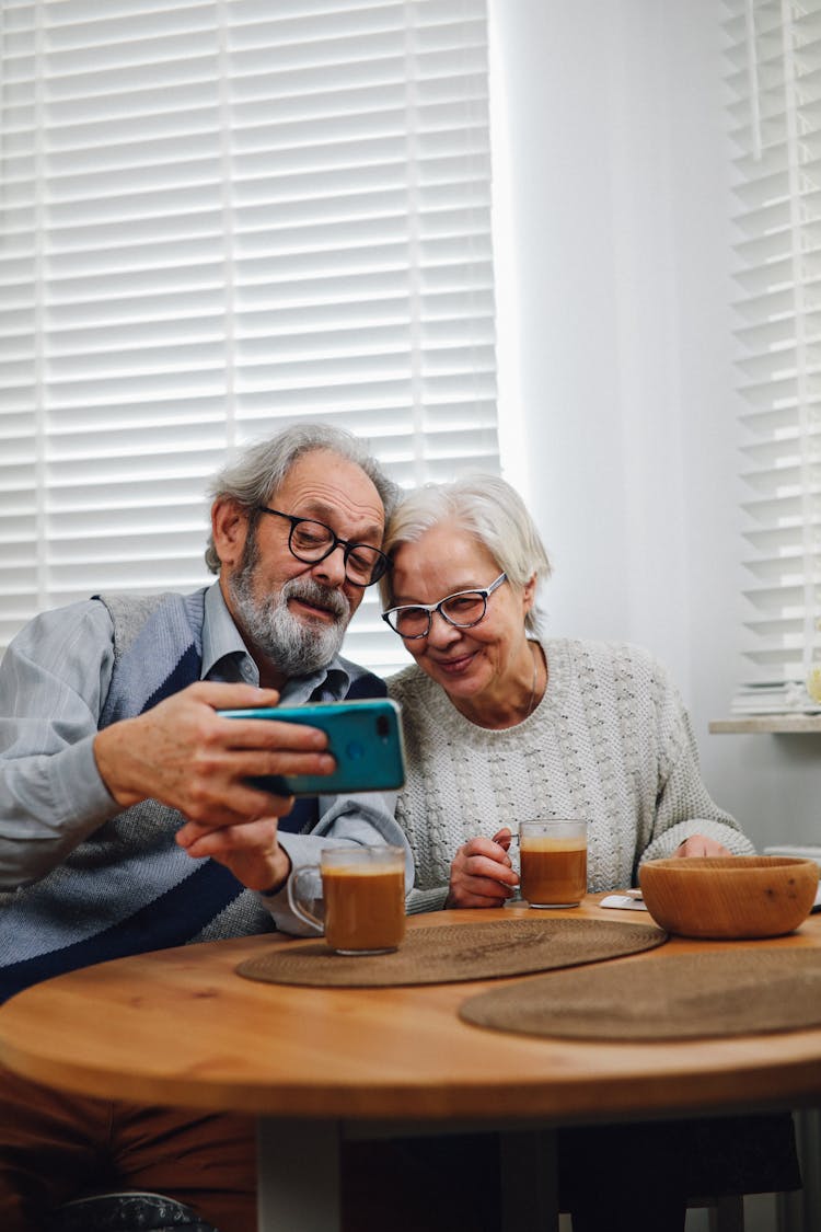 Happy Old Couple Taking Selfie On Mobile Phone