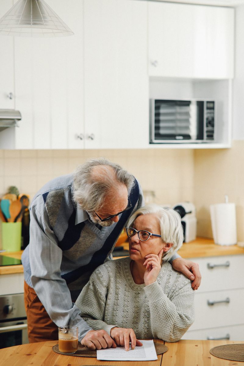 A couple going over paperwork together at home