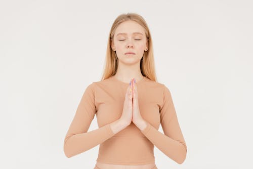 Free A Woman in Beige Sleeves Doing a Yoga Stock Photo