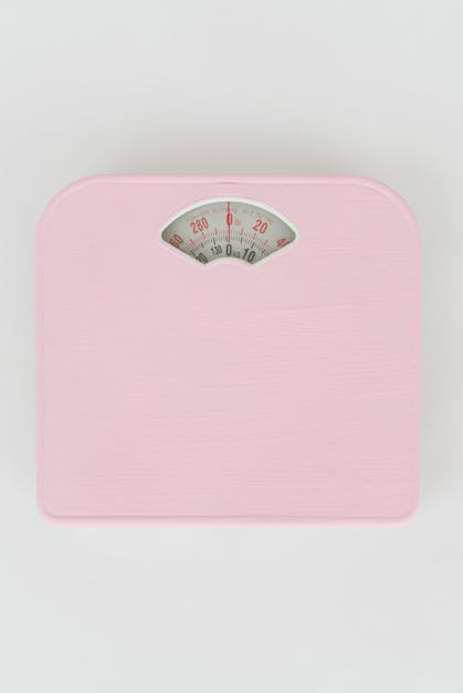 Pink Weighing Scale on a White Surface · Free Stock Photo