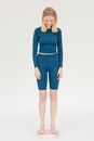 Slim woman in sportswear checking weight on scales