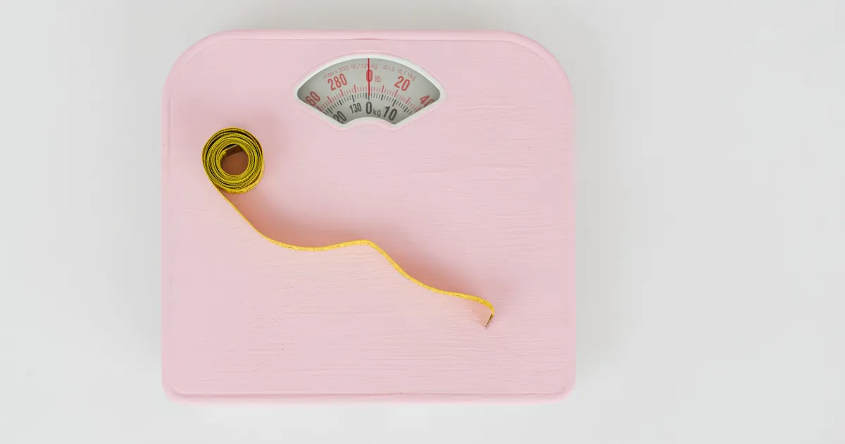 Bathroom scales and a tape measure seen from above