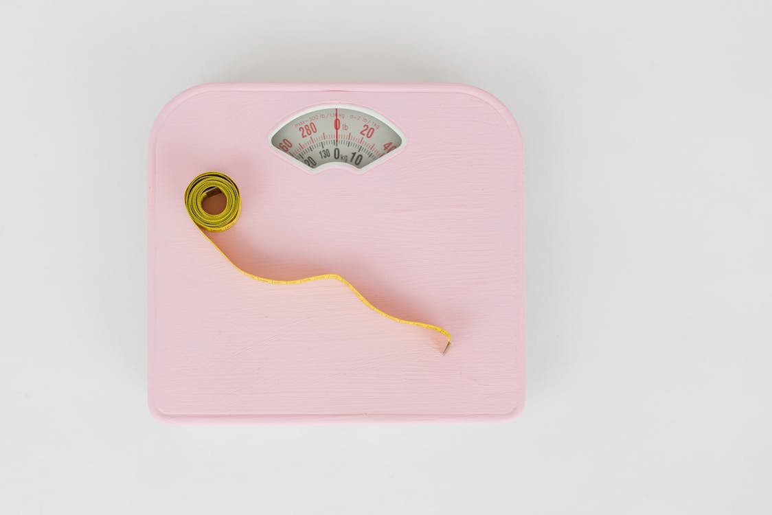 Free Measuring Tape on a Weighing Scale  Stock Photo