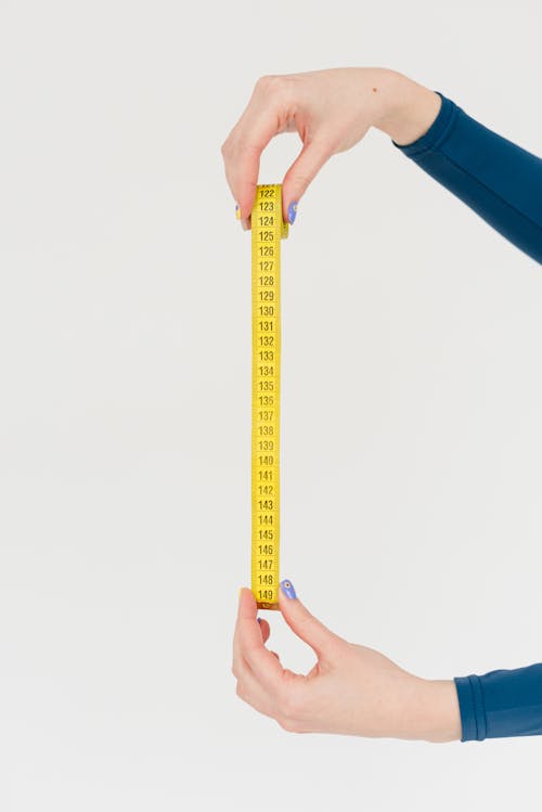 Woman showing measuring tape for checking body forms