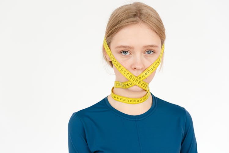 Sad Woman With Measuring Tape On Face