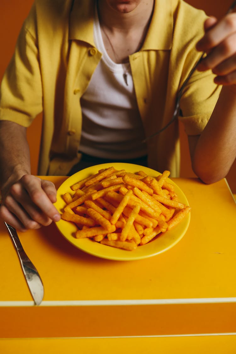 Crop Photo Of Man Eating A Bowl Of Fries