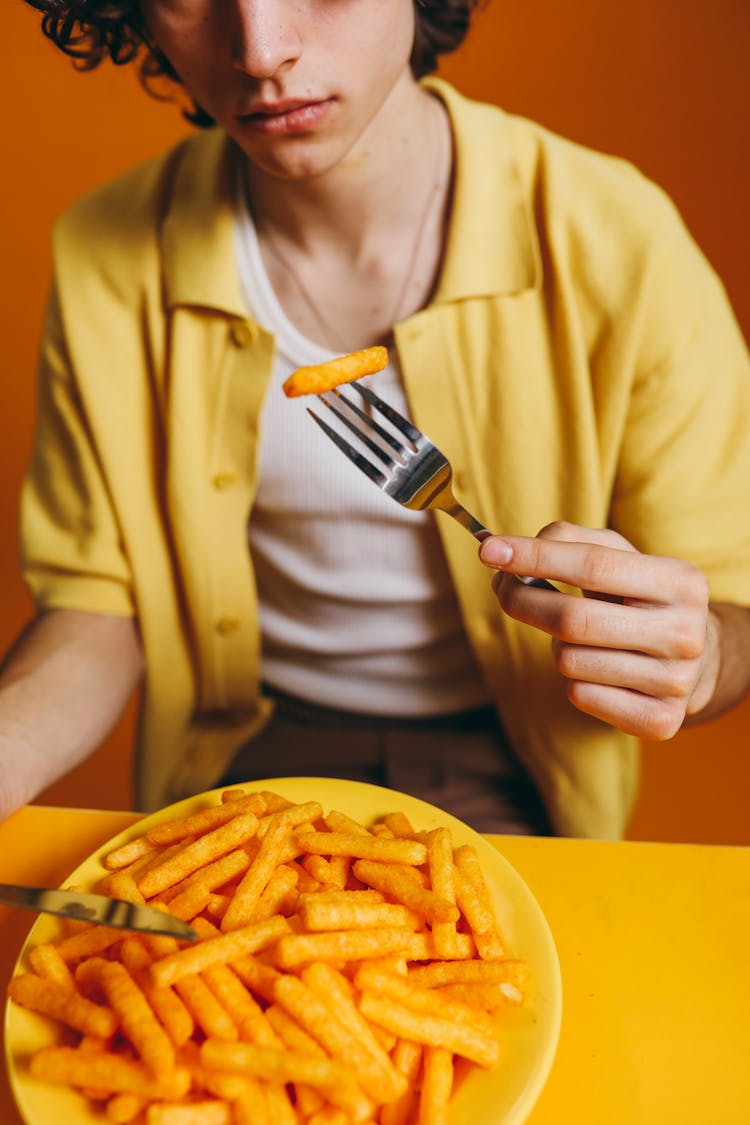 Crop Photo Of A Young Man Eating French Fries