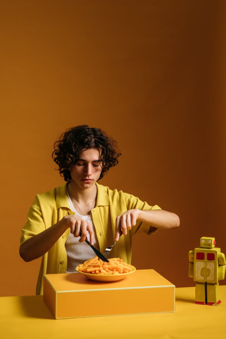 A Young Man Eating French Fries