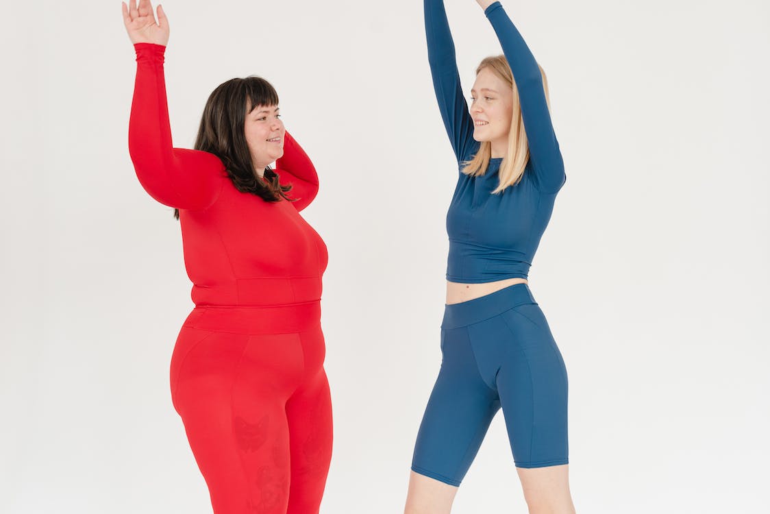 Free Active sporty women with different body types of Stock Photo
Curvy woman in red, while skinny one in blue