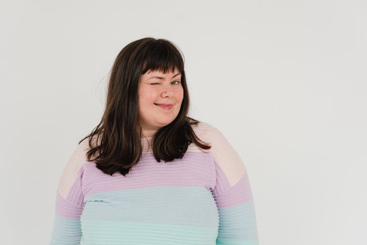 Cheerful Plump Woman Winking At Camera