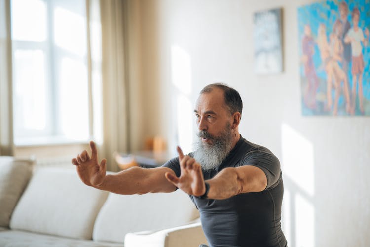 An Elderly Man Exercising At Home