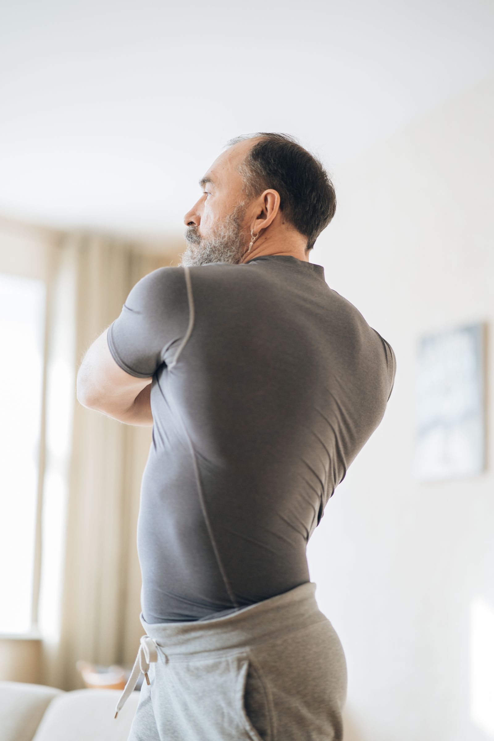 Mature man starting a gentle morning movement routine