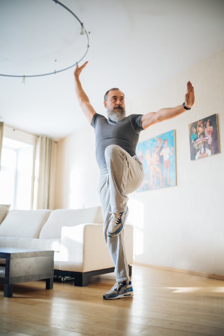 An Elderly Man Exercising At Home