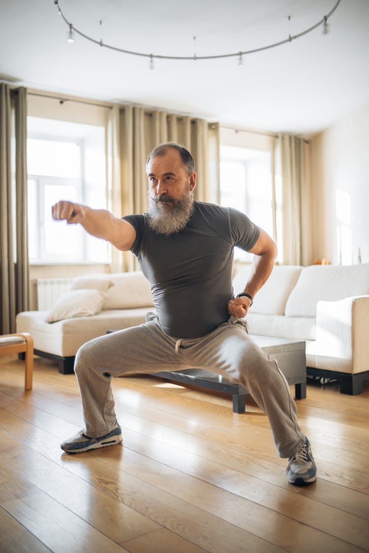 An Elderly Man Exercising At Home