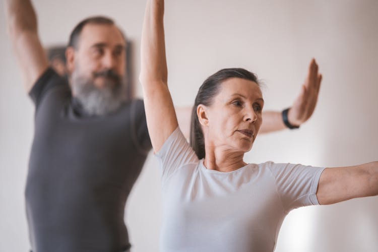 A Mature Woman In White Shirt Dancing