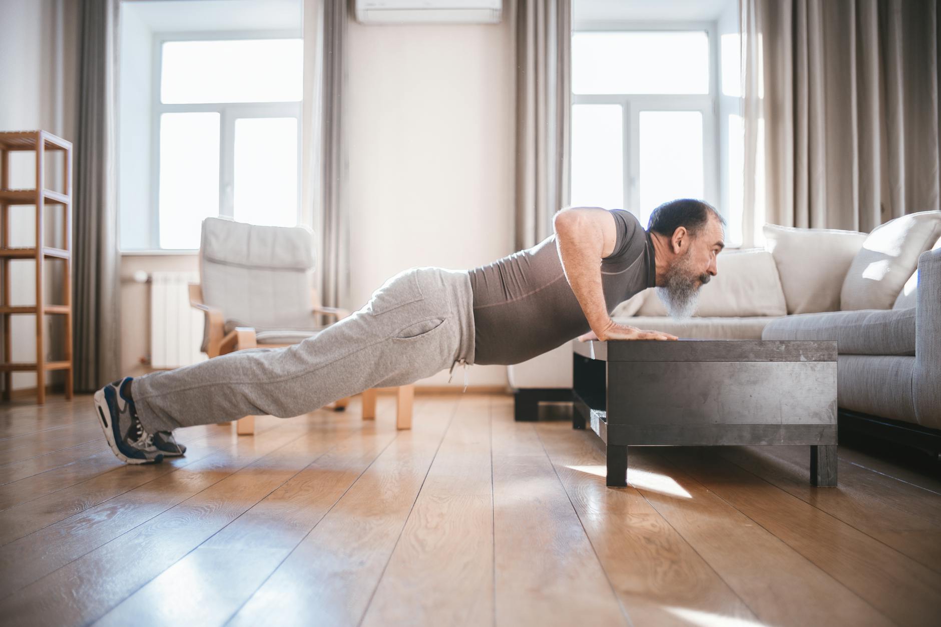 A Man Doing Push Ups on the Table