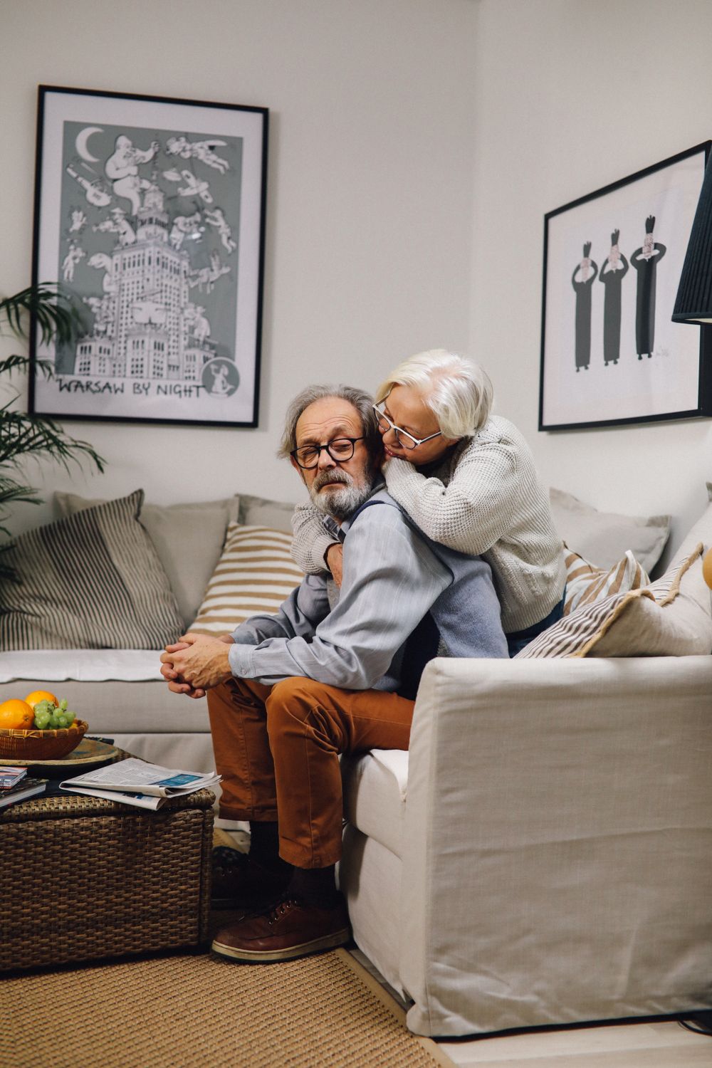 A senior couple sharing a warm moment on the sofa at home