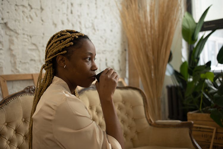 Side View Of A Woman Sipping Tea