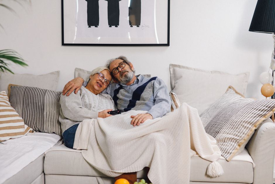older couple watching television at home