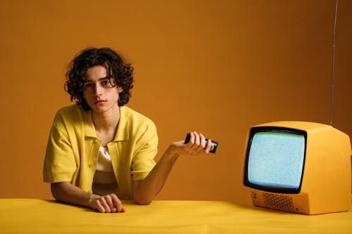 Free Young Man Holding A Remote Control Stock Photo