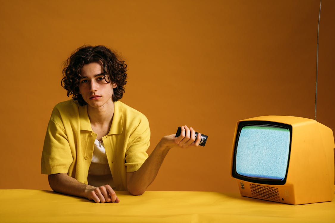 Young Man Holding A Remote Control