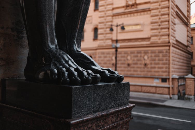 Feet Of A Black Statue On Pedestal