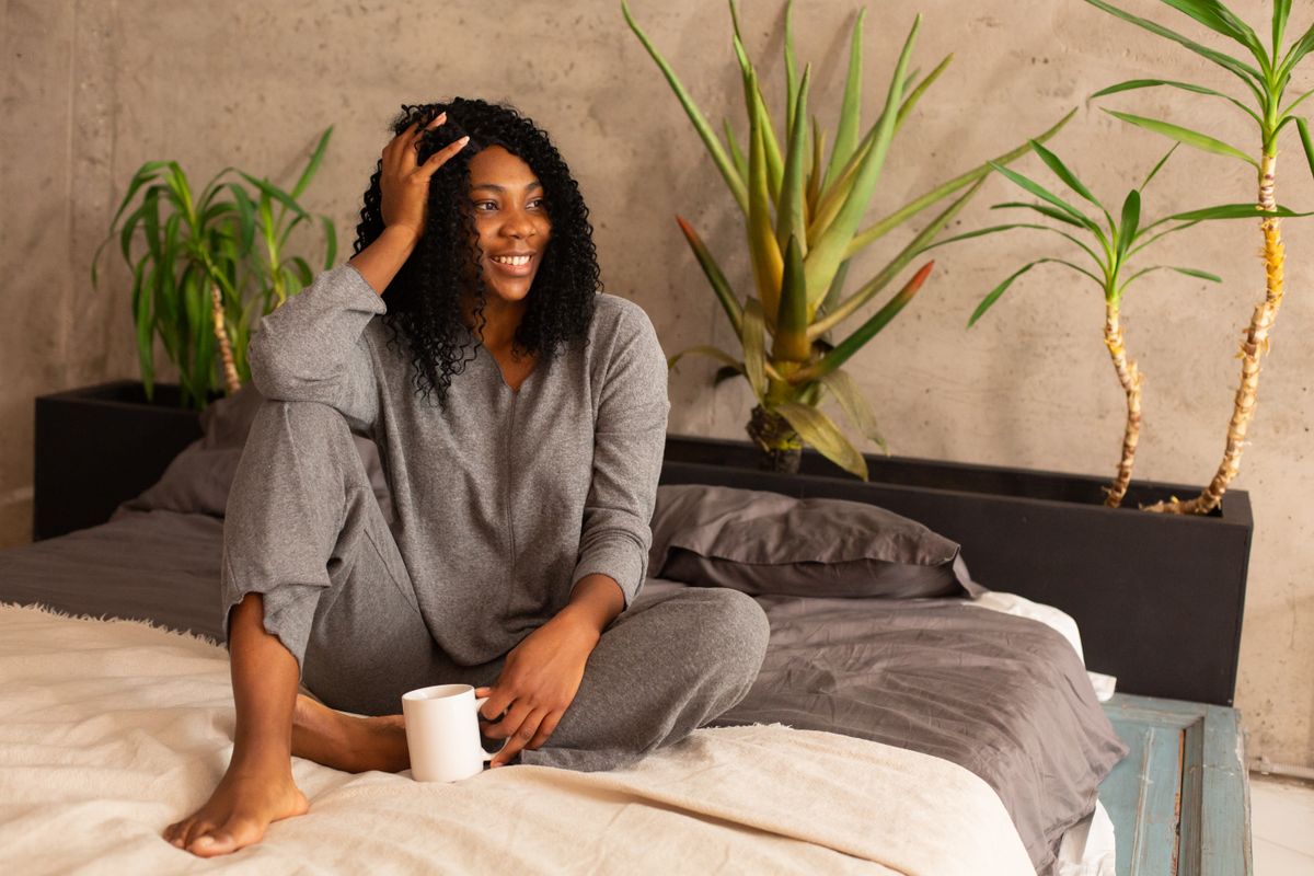 woman in soft gray sleepwear loungewear set relaxing at home