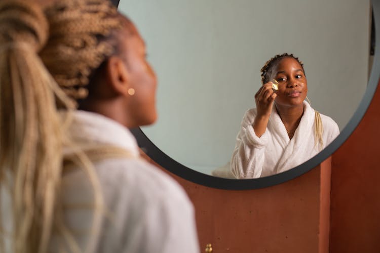 Woman Looking In Mirror Doing Beauty Procedures