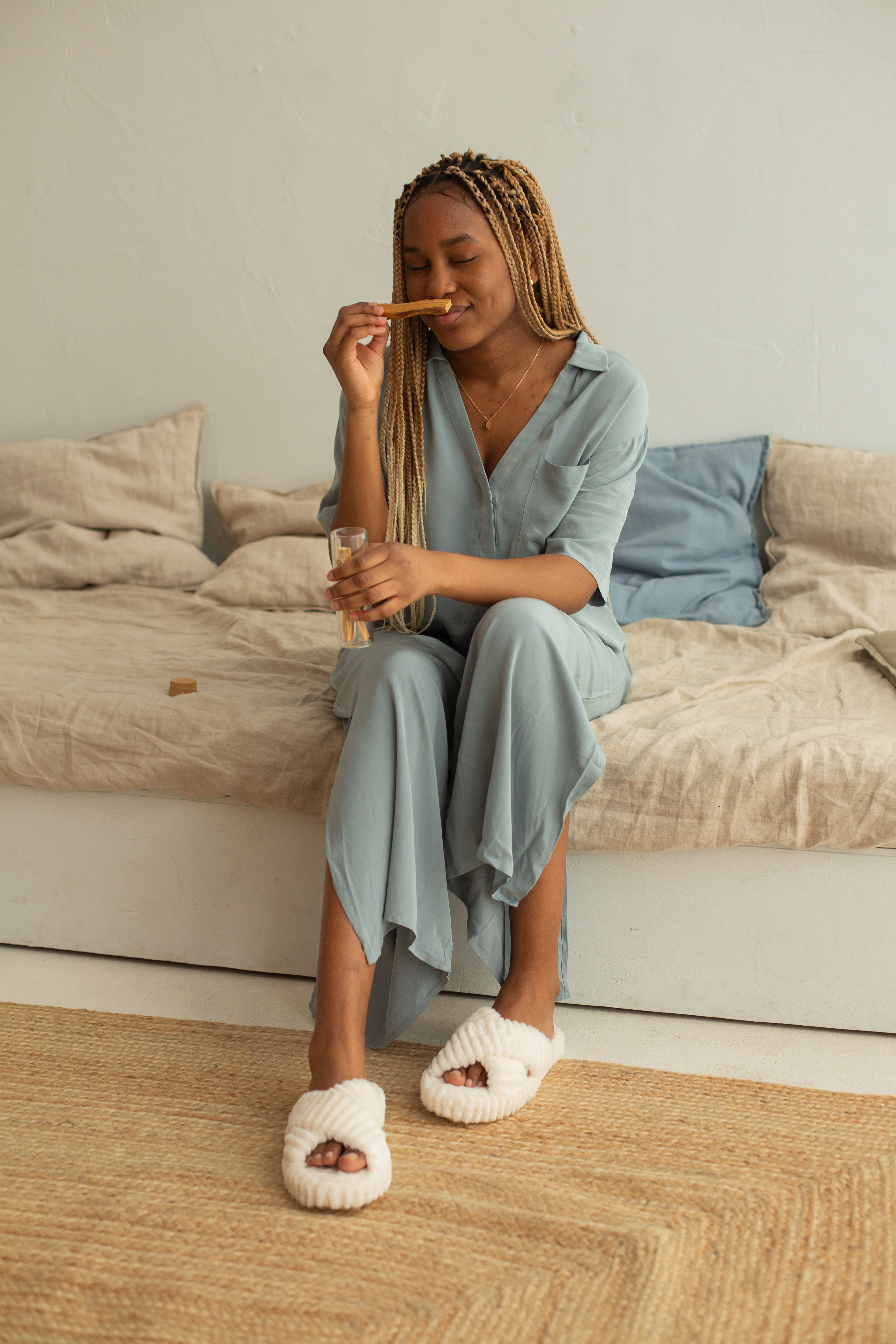 Woman in Blue Dress Sitting on a Sofa · Free Stock Photo